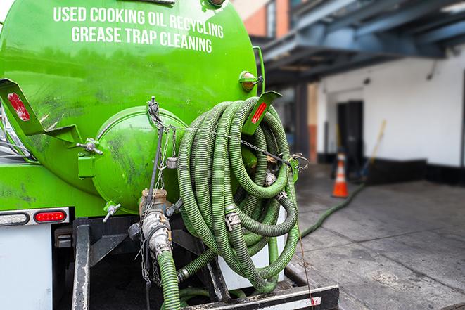 a technician pumping a grease trap in a commercial building in Sandwich IL